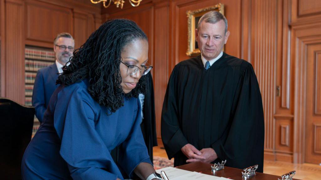 Ketanji Brown Jackson signing the Oath of Office at the Supreme Court