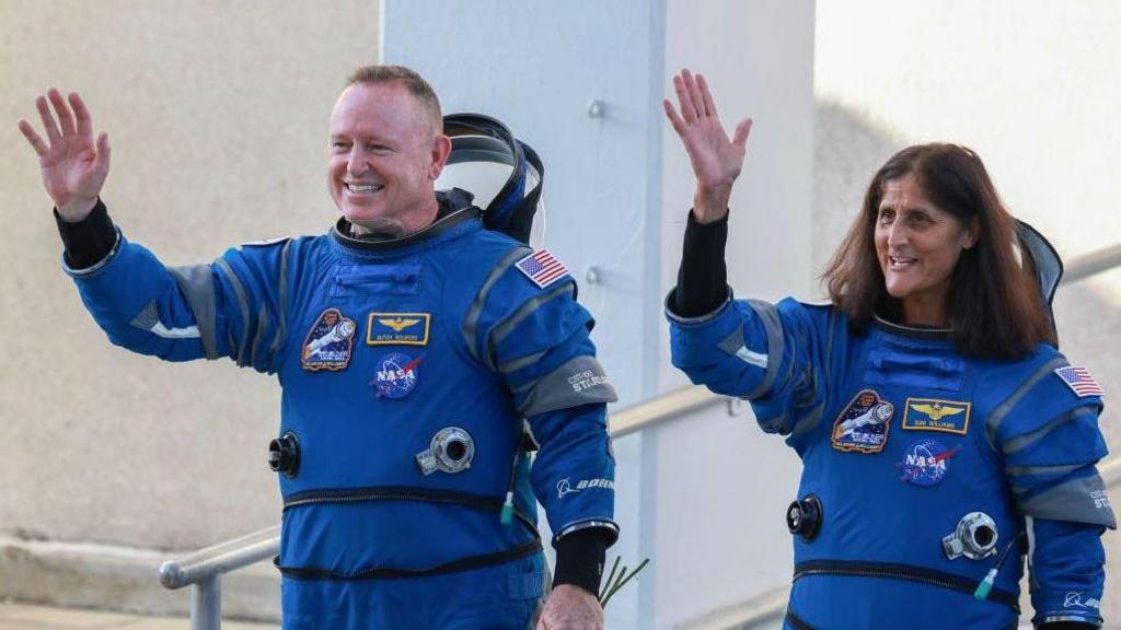 Butch Wilmore and Suni Williams smiling and waving before their mission.