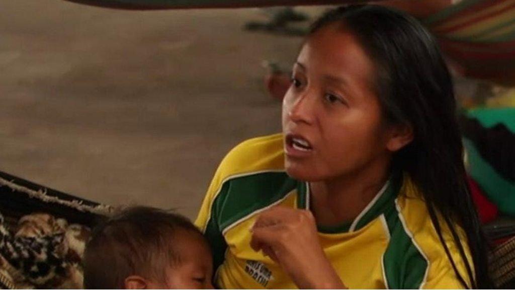 Woman in shelter feeding baby