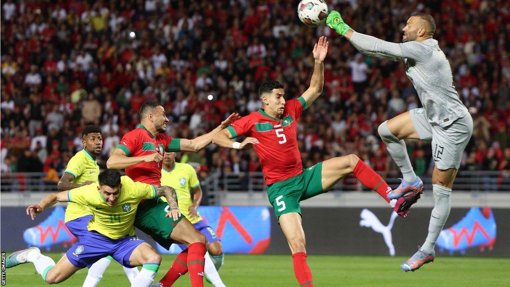 Morocco and Brazil players contest the ball