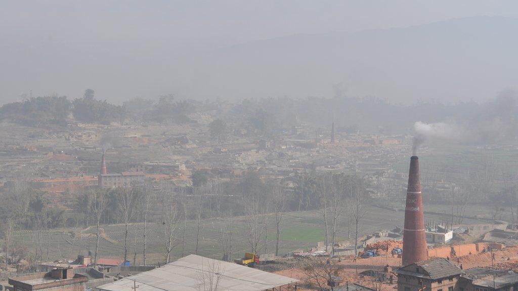 With the Himalayas in the background, brick kilns still belch out smoke