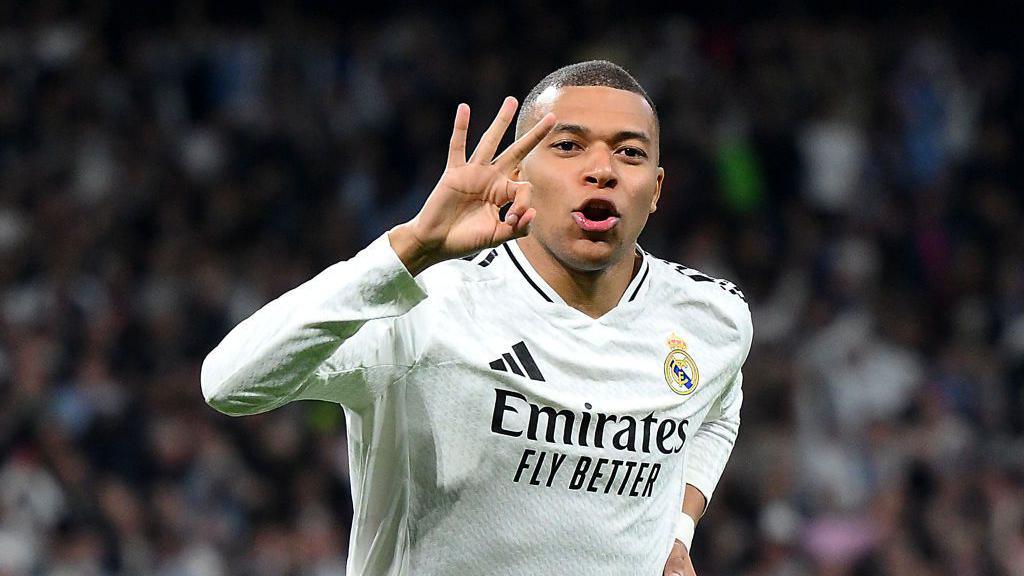 Kylian Mbappe of Real Madrid celebrates scoring his team's third goal and his hat trick 