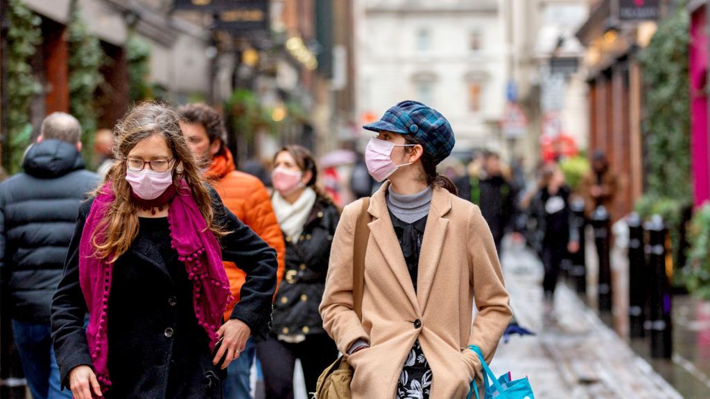 People wearing face masks as a preventive measure while walking along Floral Street in London on 5 December 2021