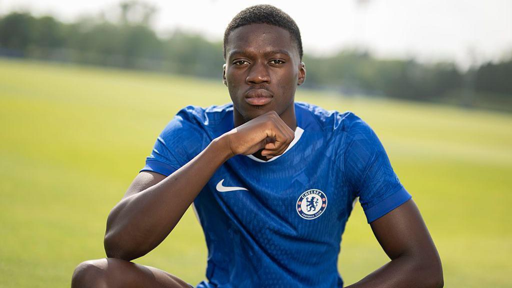 Mamadou Sarr poses in a Chelsea kit at the training ground