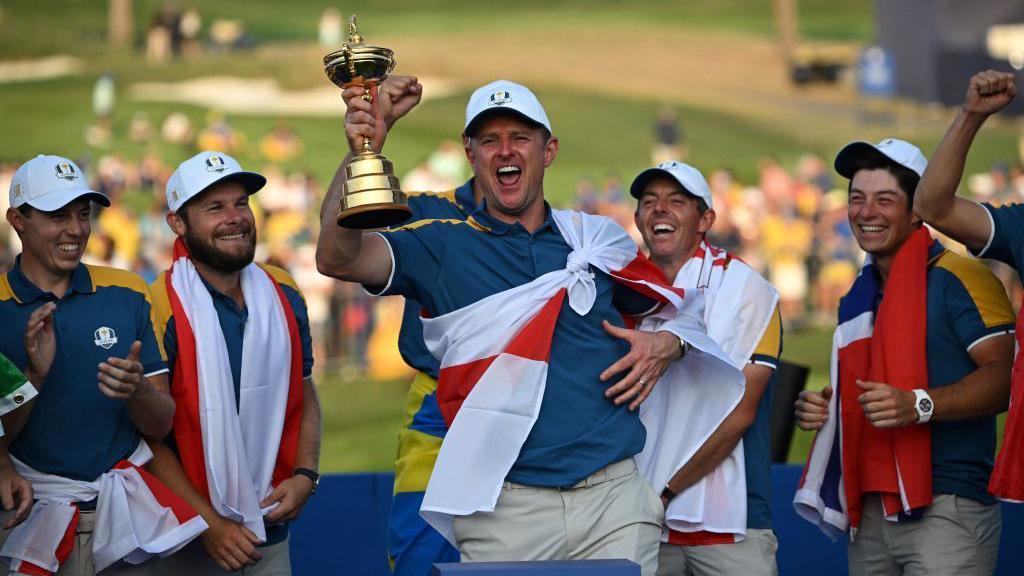 Justin Rose (c) raises the Ryder Cup after team Europe defeat Team USA in 2023