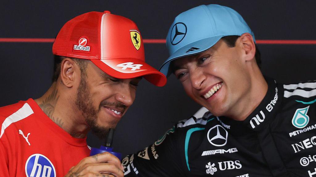 Lewis Hamilton and George Russell share a joke during the official news conference after qualifying for the Barcelona-Catalunya Grand Prix