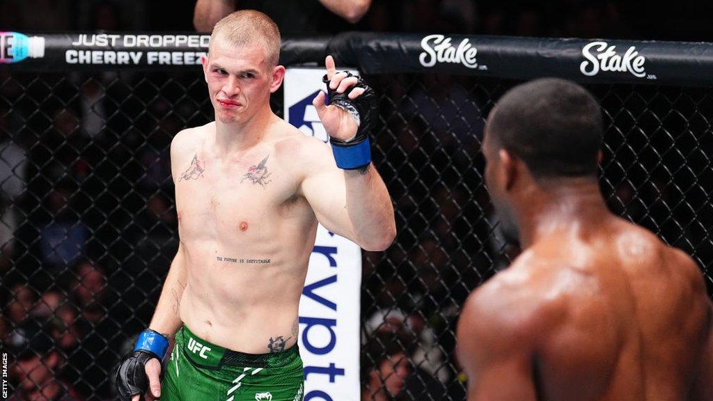 Ian Machado Garry gestures towards Geoff Neal during their bout at UFC 298