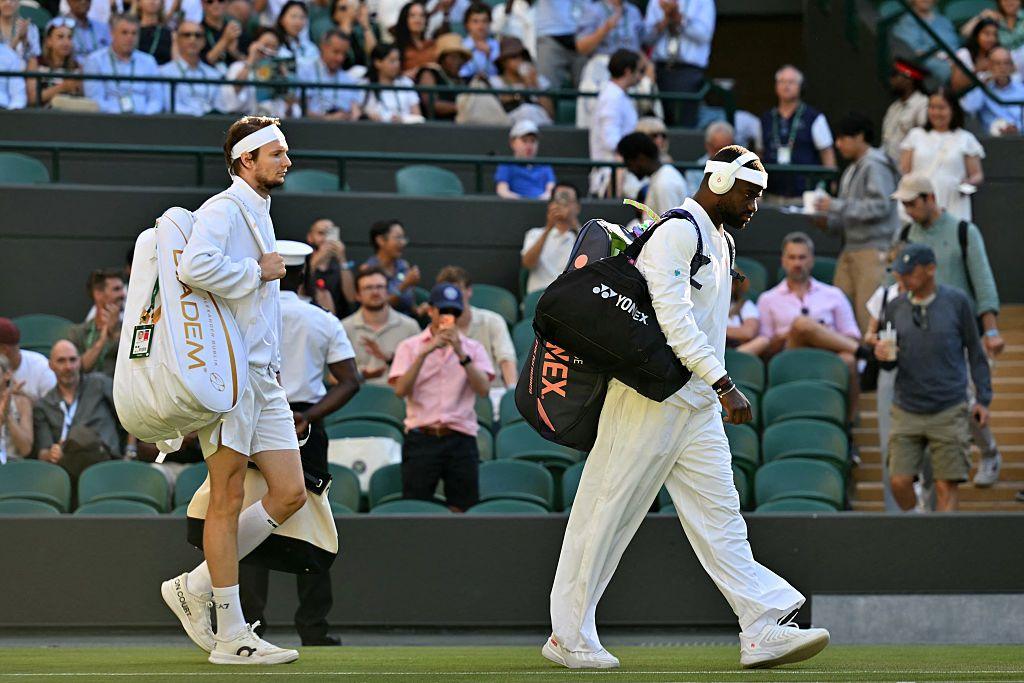 Frances Tiafoe and Alexander Bublik walk onto court