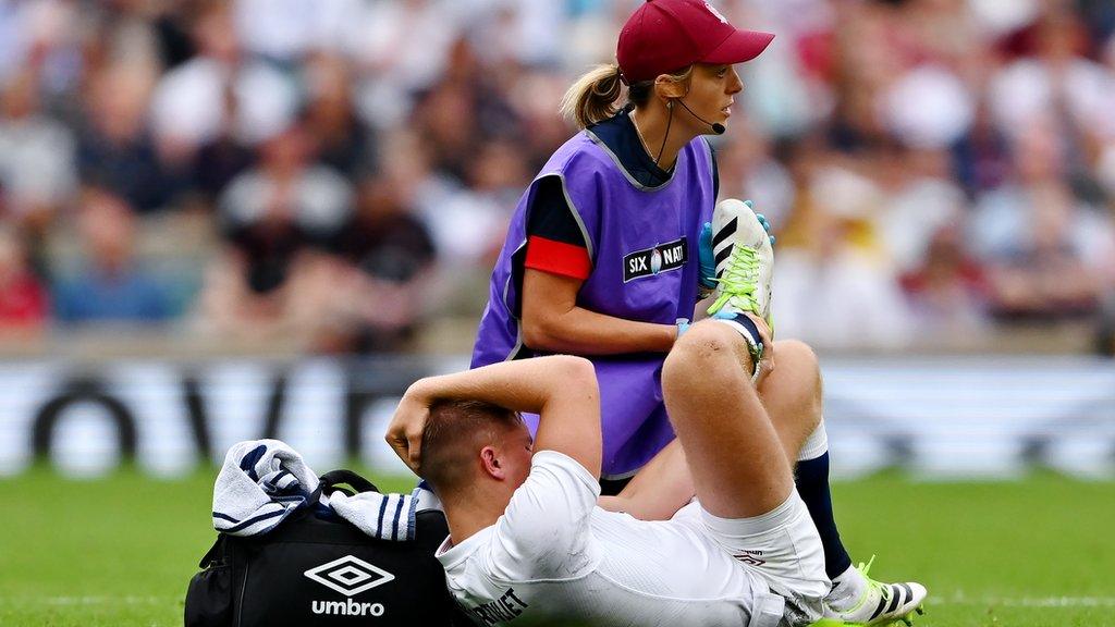 Jack van Poortvliet is treated by the physio after injuring his ankle against Wales