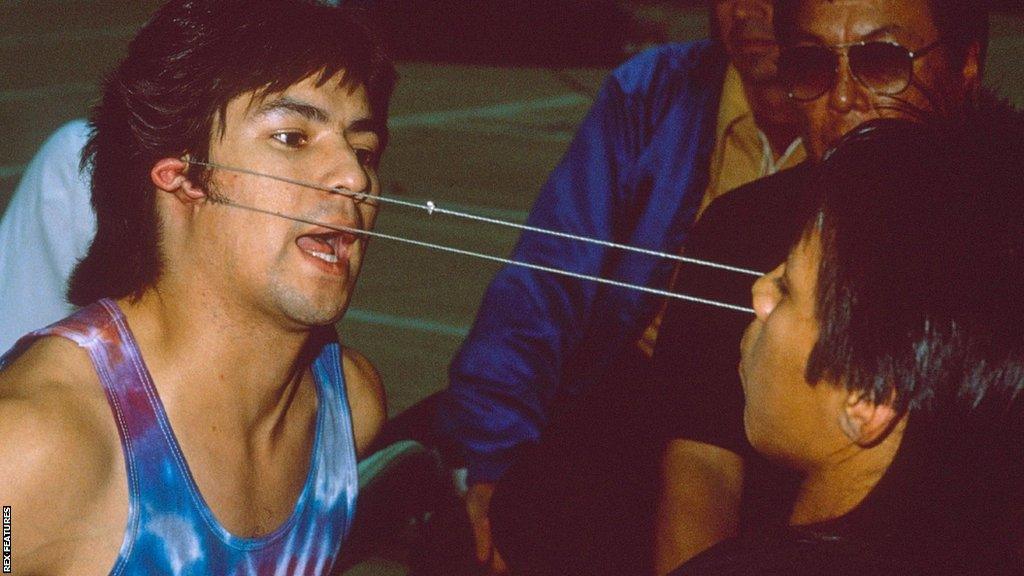 Two competitors in the ear pull event at the 1988 WEIO