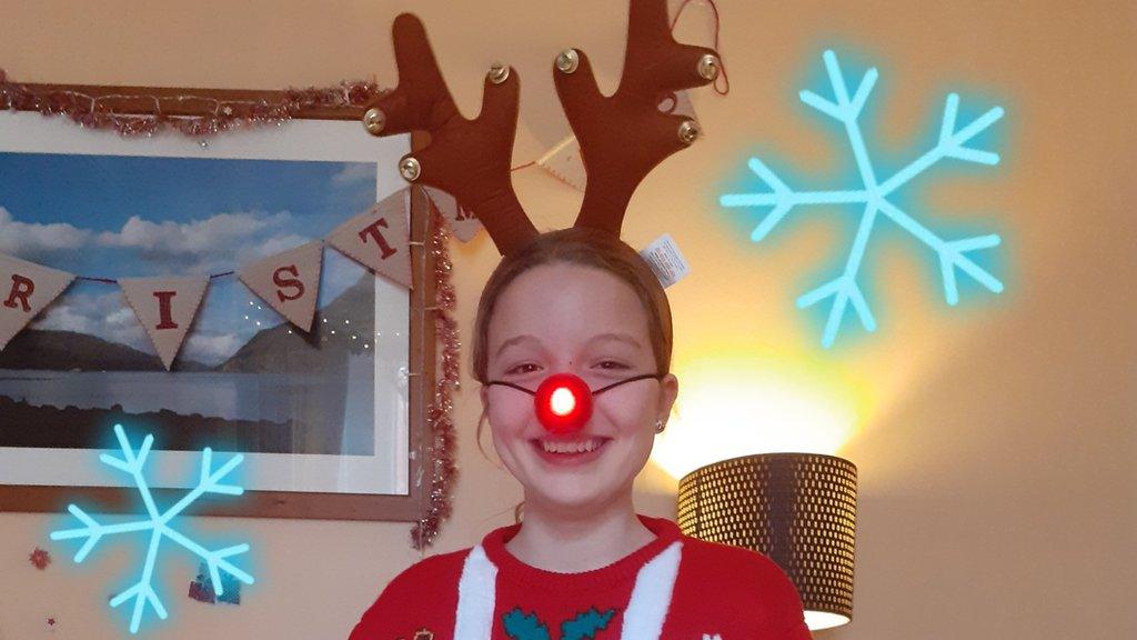 Girl in Christmas jumper.