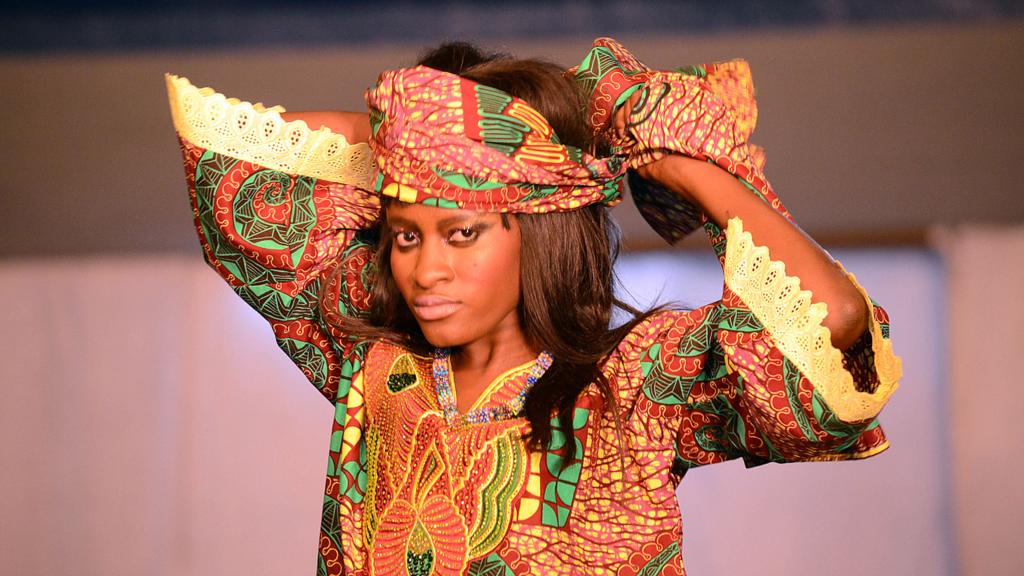 A model in Kinshasa, DR Congo tying a head wrap