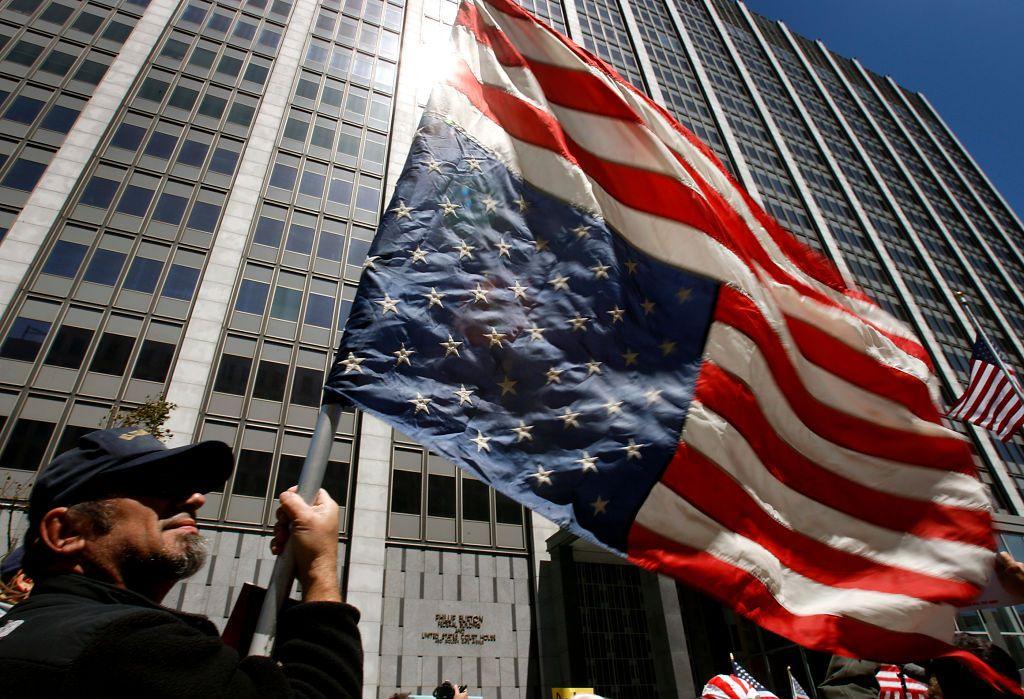 A tax protester flies an upside-down American flag at a rally in 2009