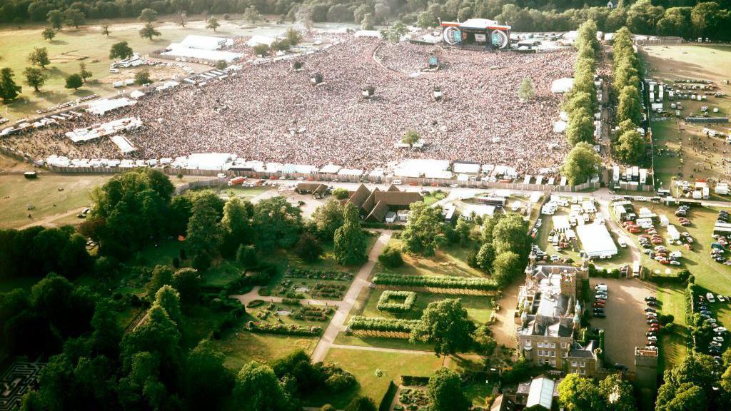 An ariel view of the huge crowds at watching Oasis at Knebworth Park, in the foreground Knebworth House can be seen