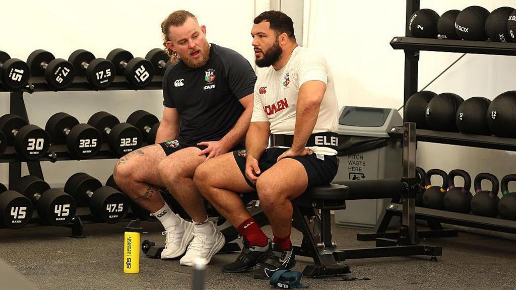 Finlay Bealham and Ellis Genge sit in the gym