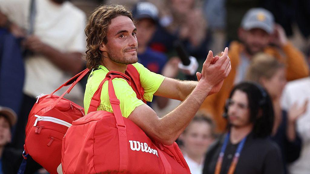 Greece's Stefanos Tsitsipas waves to spectators