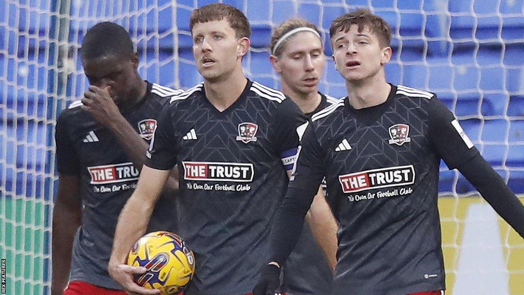 Dejected Exeter players after conceding a goal at Bolton