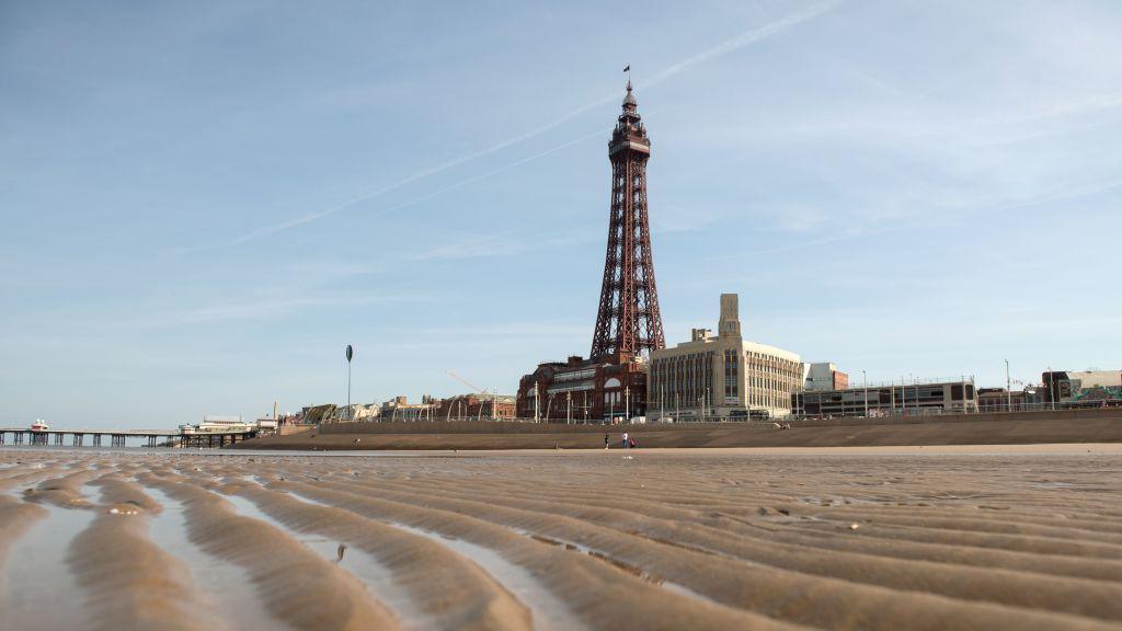 The Blackpool Tower, an iconic British landmark and tourist attraction, is seen from the beach 