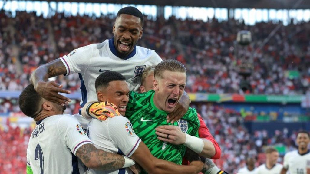 England players celebrate winning the penalty shoot-out against Switzerland at Euro 2024