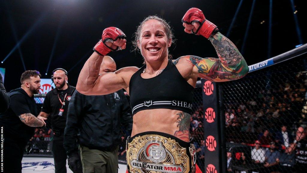 Liz Carmouche celebrates beating Juliana Velasquez