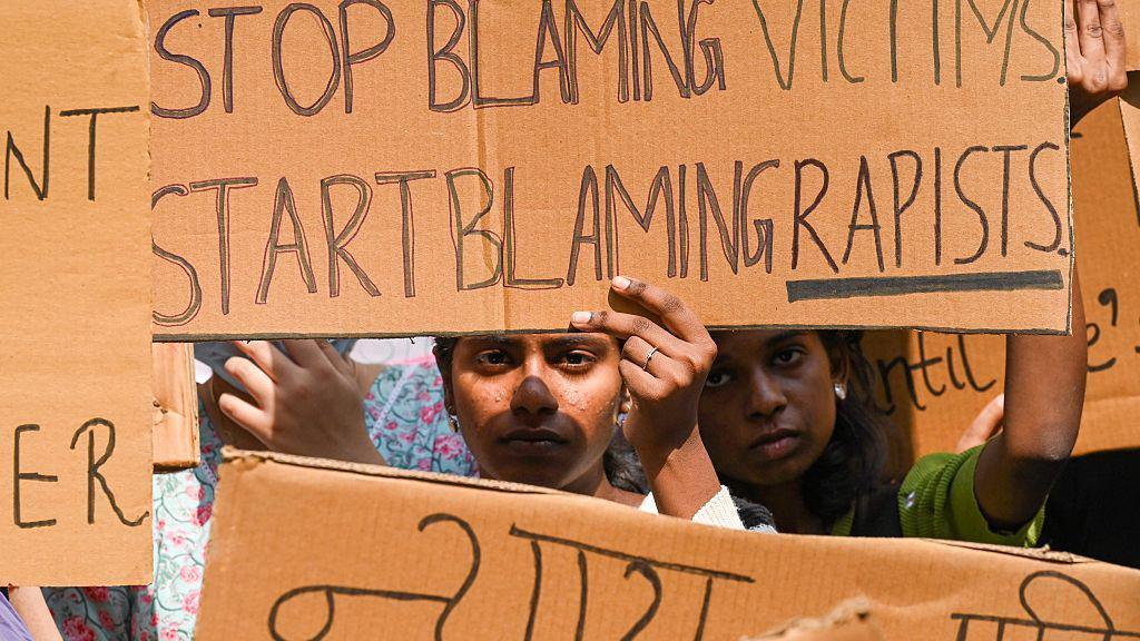 NEW DELHI, INDIA - OCTOBER 15: Students hold placards and shout slogans during a protest against sexual assault after a female student at South Asian University alleged sexual assault on campus by a security guard and his three friends. (Photo by Vipin Kumar/Hindustan Times via Getty Images)