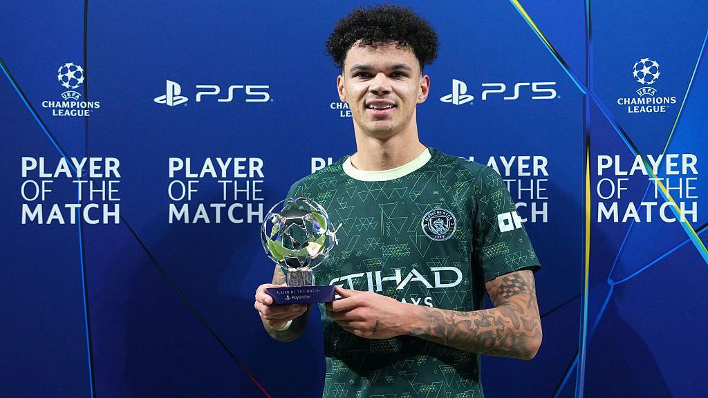 Nico O'Reilly holding a player of the match trophy