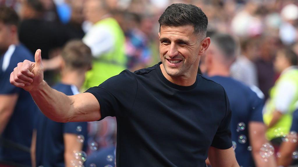 John Mousinho gives the thumbs up before the EFL Cup game at West Ham