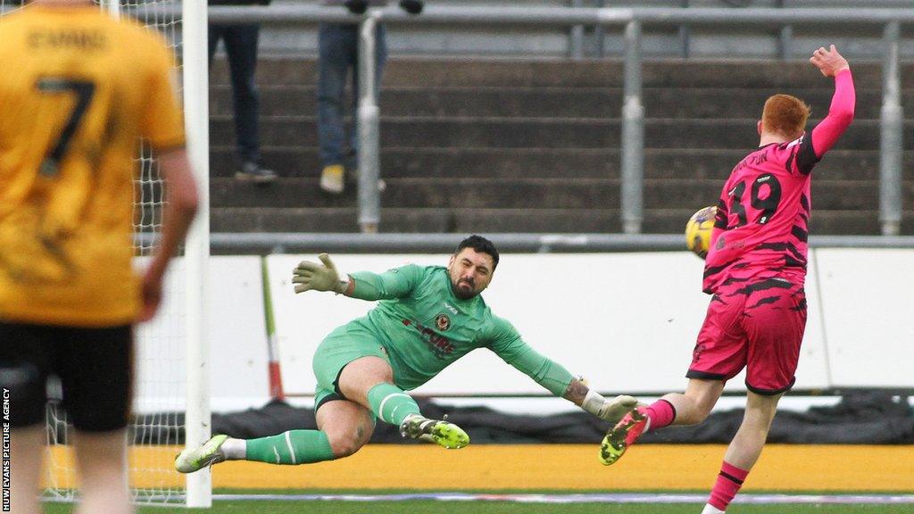 Newport County goalkeeper Nick Townsend saves at the feet of Callum Morton of Forest Green Rovers