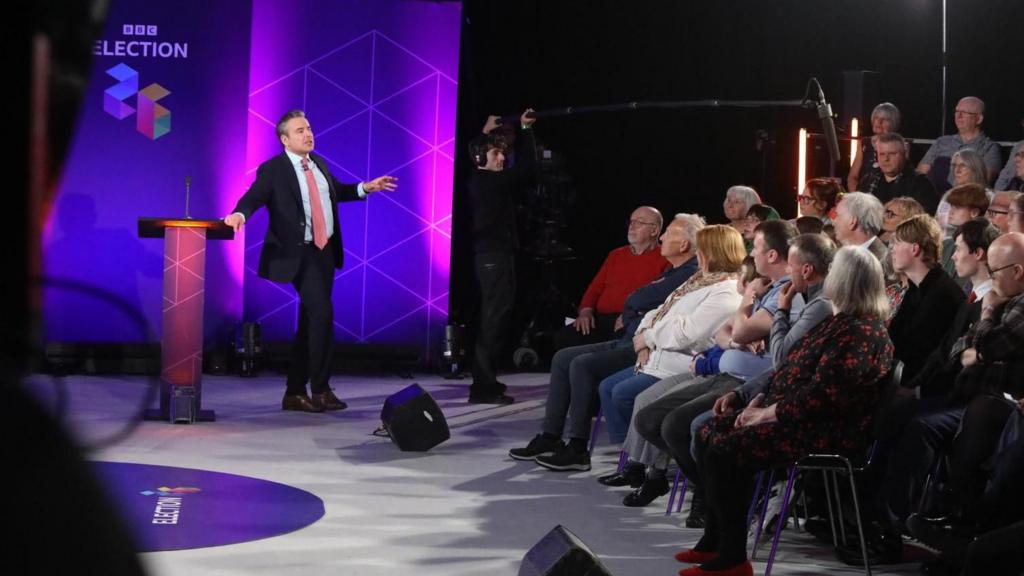 Nick Servini stood in front of a seated audience