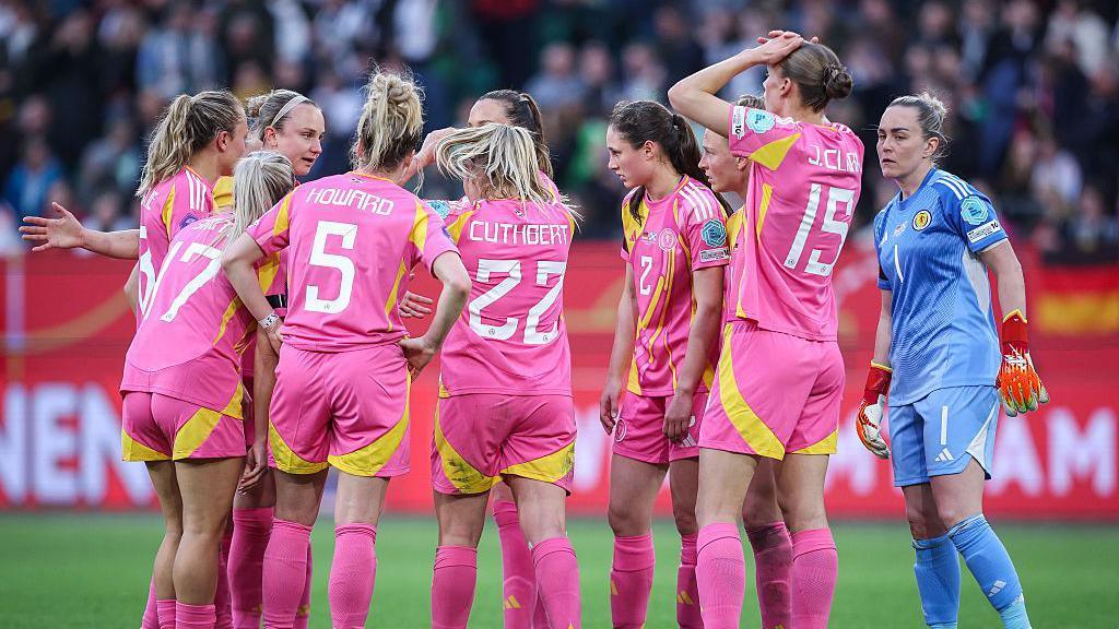 Scotland players having a serious discussion after Germany's fifth goal.