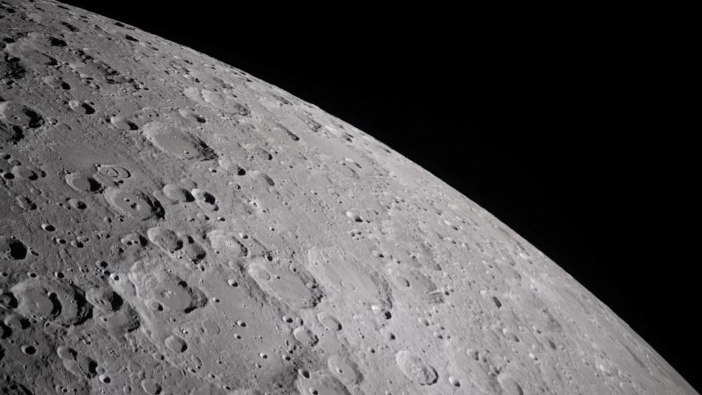 Craters dotting the surface of the Moon, revealing its rugged, ancient surface.
