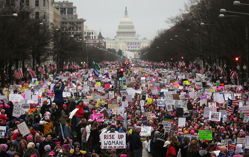 Protesters walk during the Women's March on Washington, with the U.S. Capitol in the background, on January 21, 2017 in Washington, DC