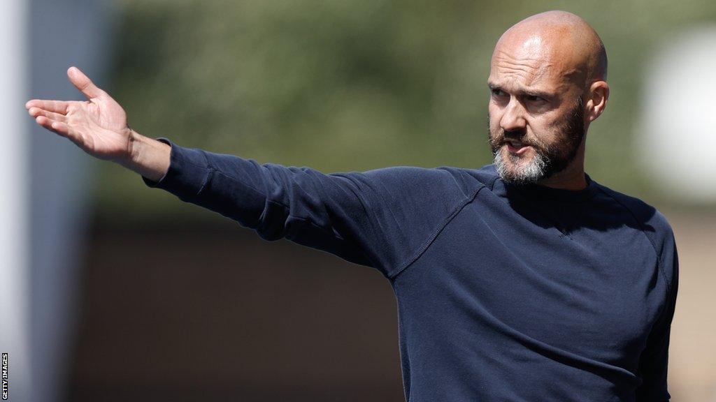 Notts County boss Luke Williams has his arm out as he directs his players