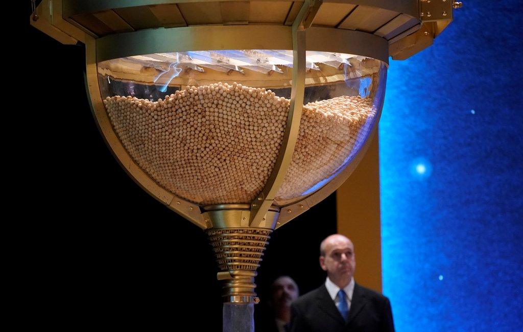 Lottery balls are collected before the start of the Christmas lottery in Madrid.