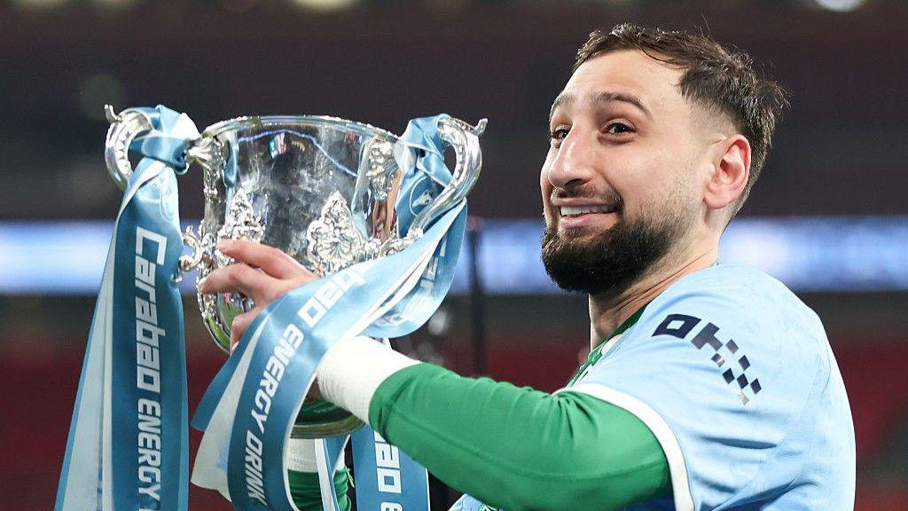 Gianluigi Donnarumma lifting the 2025-26 EFL Cup trophy