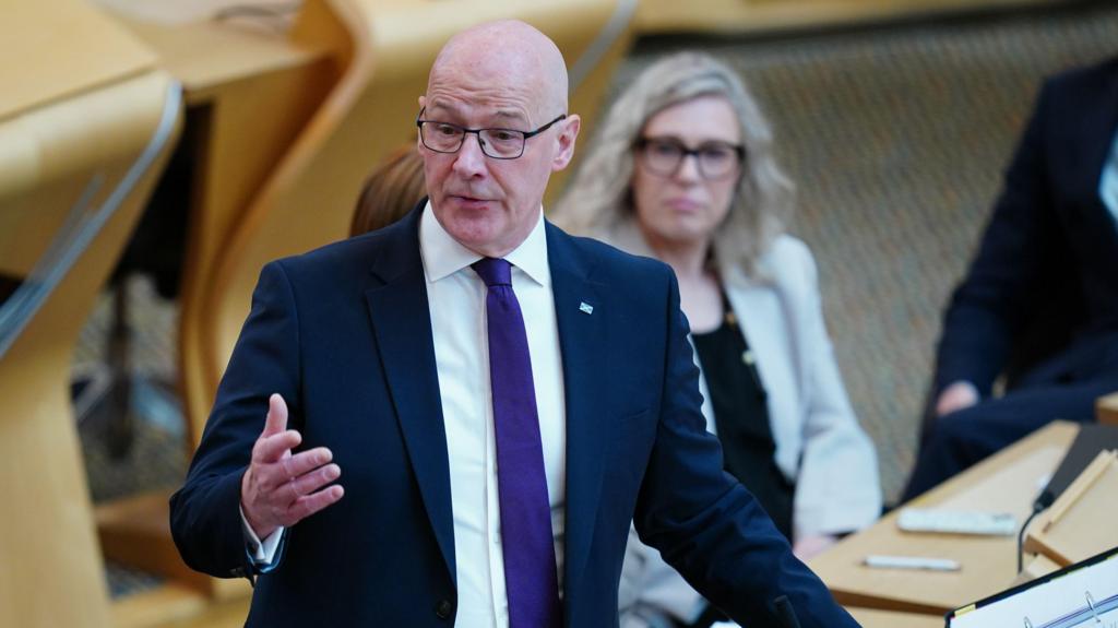 John Swinney fields questions from backbench MSPs with Gillian Martin sitting in the background