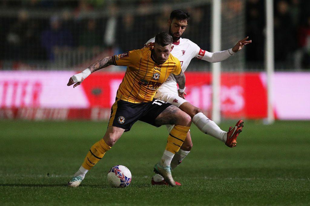 Scot Bennett shields the ball from Manchester United's Bruno Fernandes