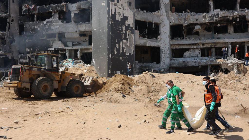 Palestinian forensic and civil defence recover bodies at the grounds of Al-Shifa hospital