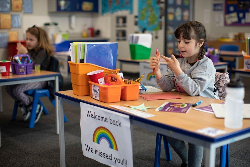 school-girl-in-socailly-distanced-classroom