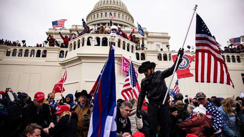 A crowd of rioters storm the US Capitol on 6 January 2021