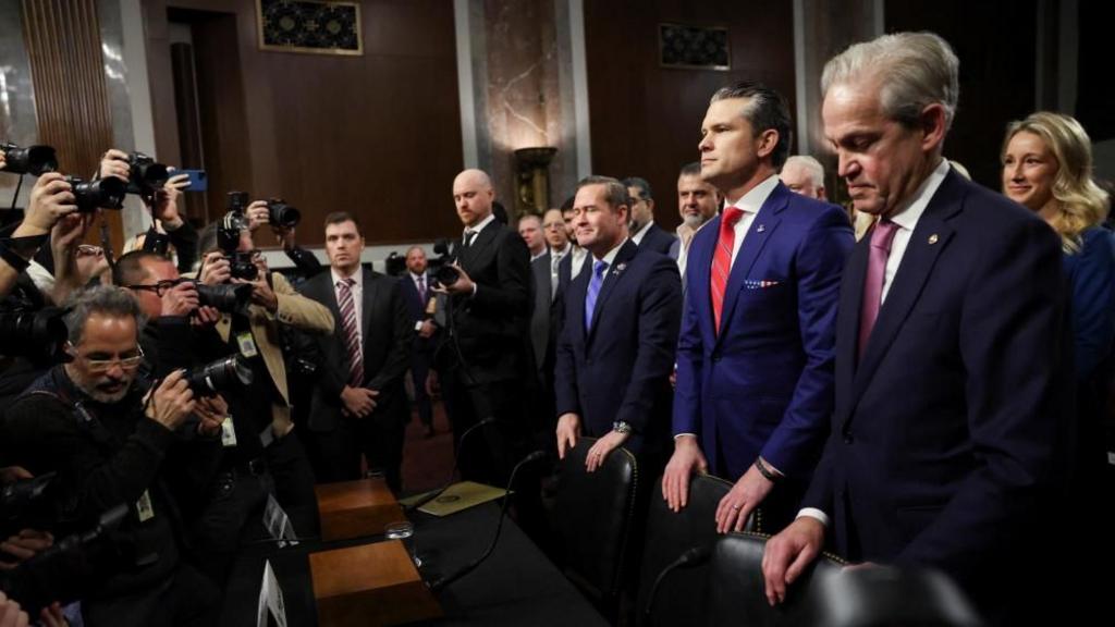 Pete Hegseth in the chamber surrounded by press photographers