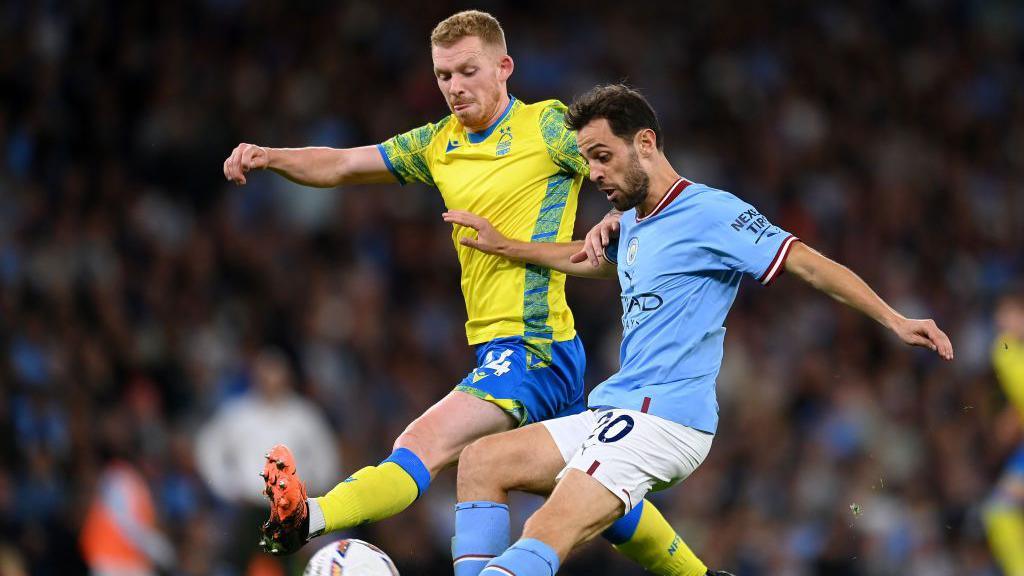 Lewis O'Brien tackles Bernardo Silva of Manchester City