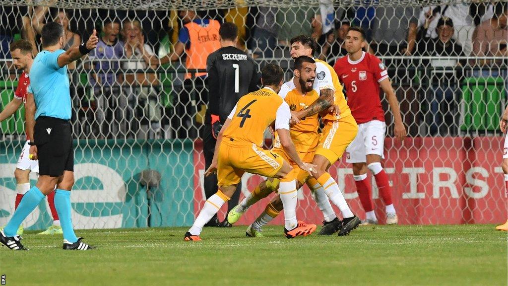 Moldova celebrate their third goal against Poland