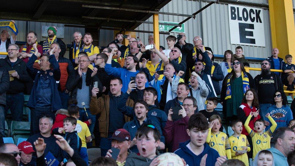 Barry Town supporters celebrate the club's Cymru South title win