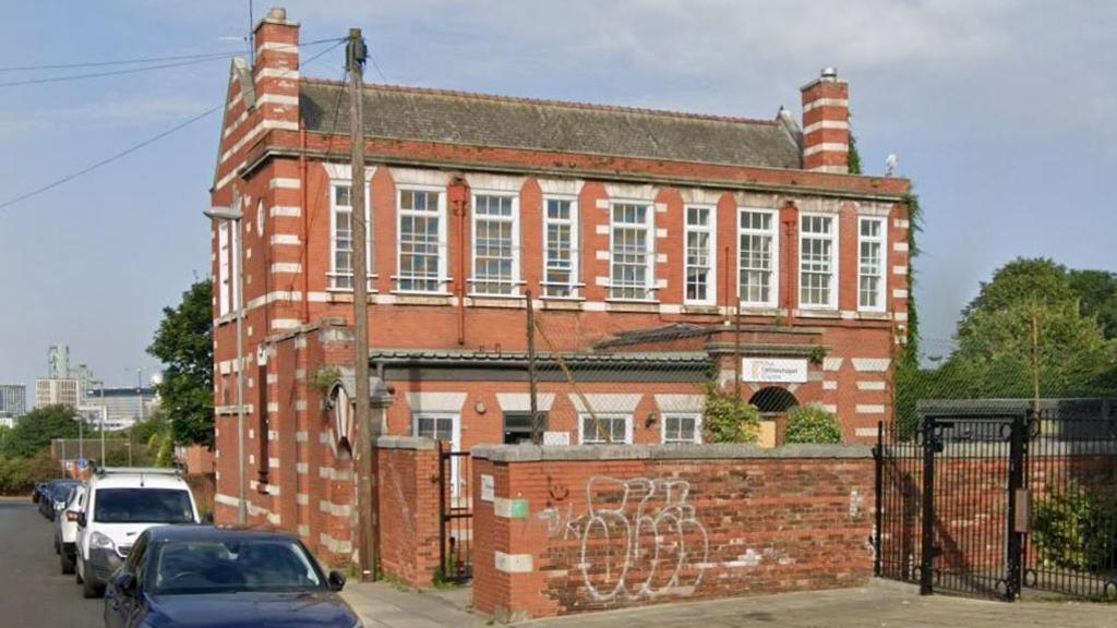 The Whitechapel Centre is a red-brick building with large Georgian style windows. 