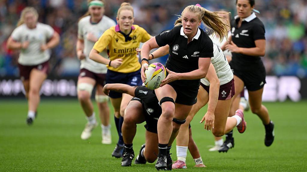 Jorja Miller running with the ball