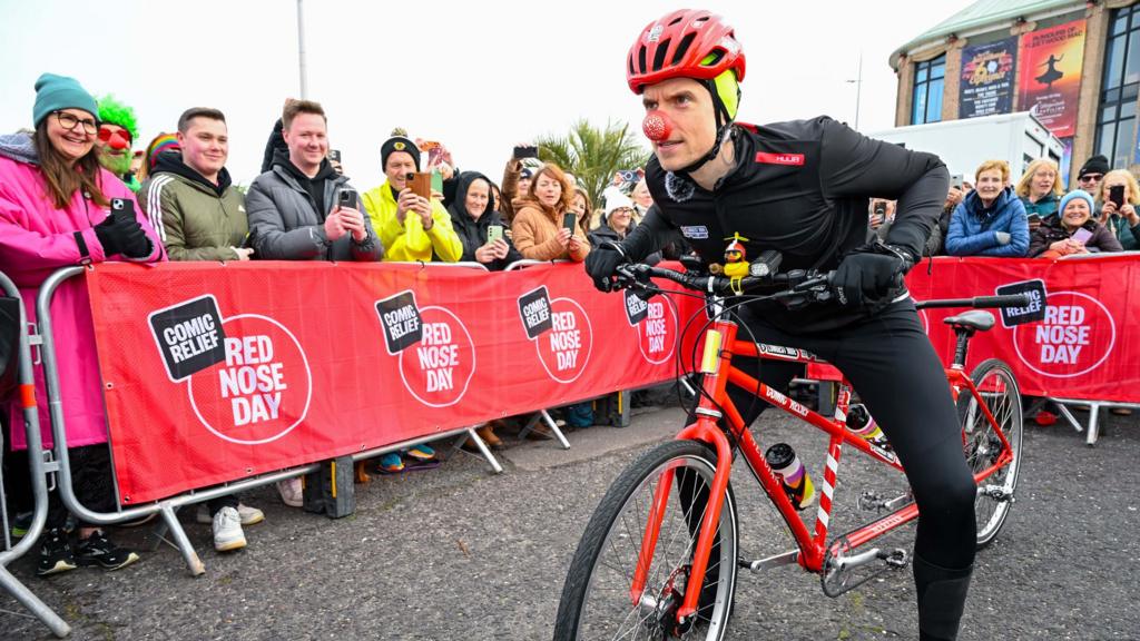 Greg James on his tandem bike at the start of Radio 1's Longest Ride for Red Nose Day