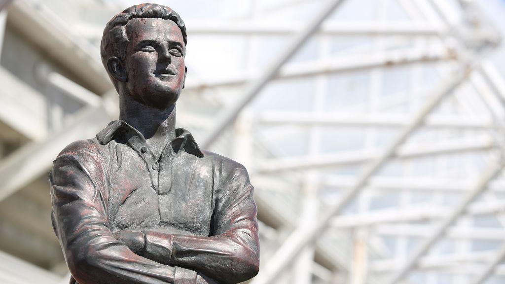 Statue of Ivor Allchurch with arms folded in front of a stadium