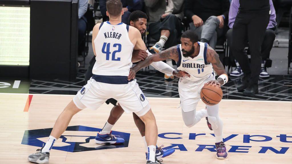 LA Clippers forward Paul George gets screened by Dallas Mavericks forward Maxi Kleber, allowing Mavericks guard Kyrie Irving to move into space with the ball