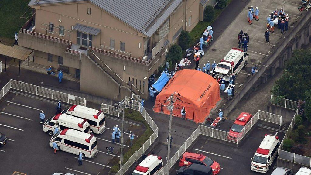 An orange tent and emergency vehicles